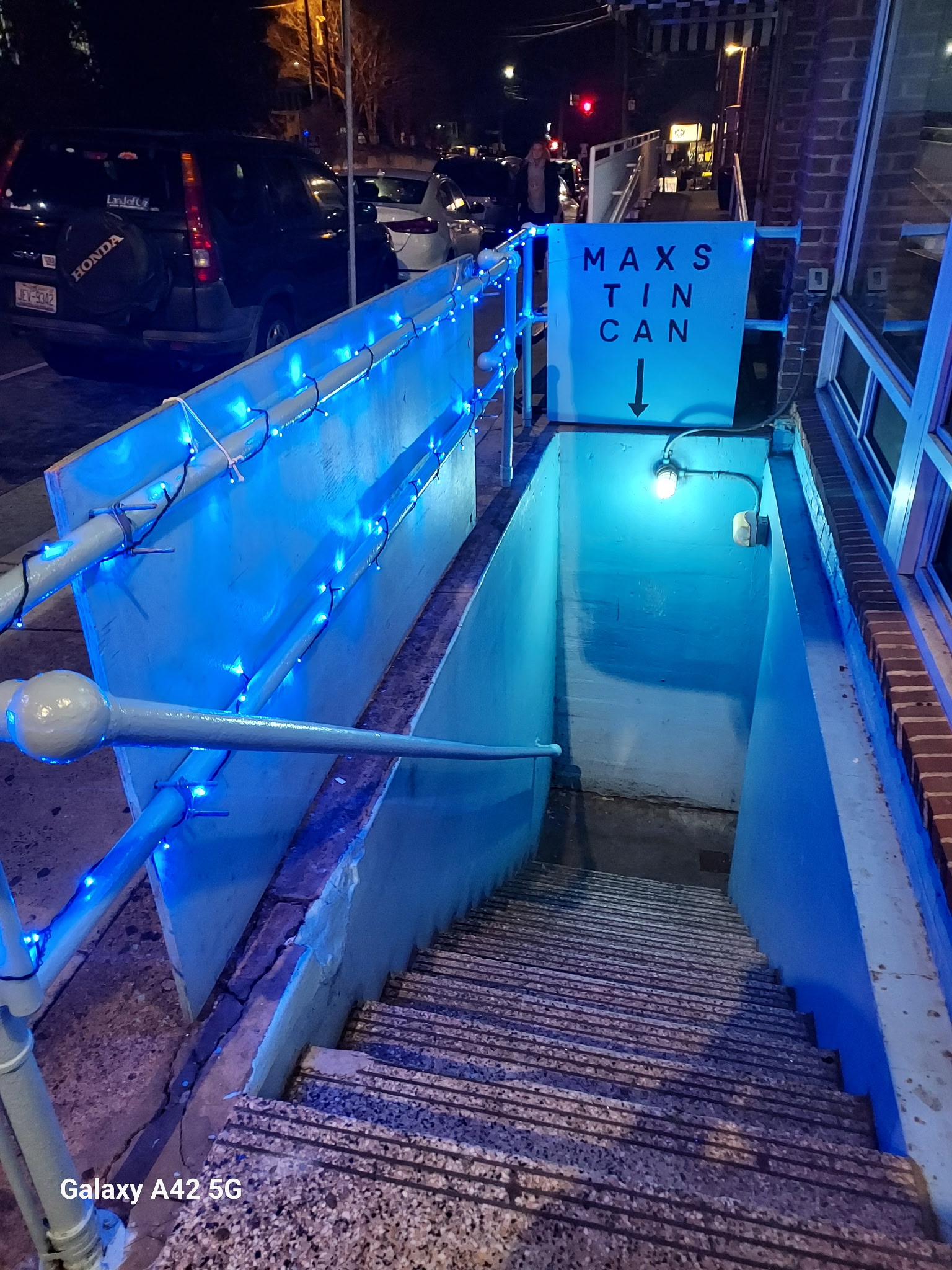 The Max's Tin Can stairwell entrance on Franklin Street, lit blue at night