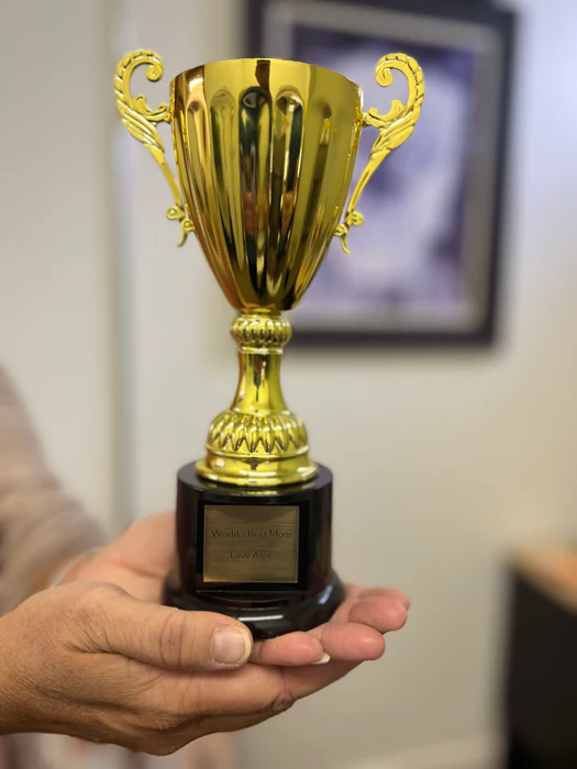 The Holy Grail: a gold trophy cup held in hand