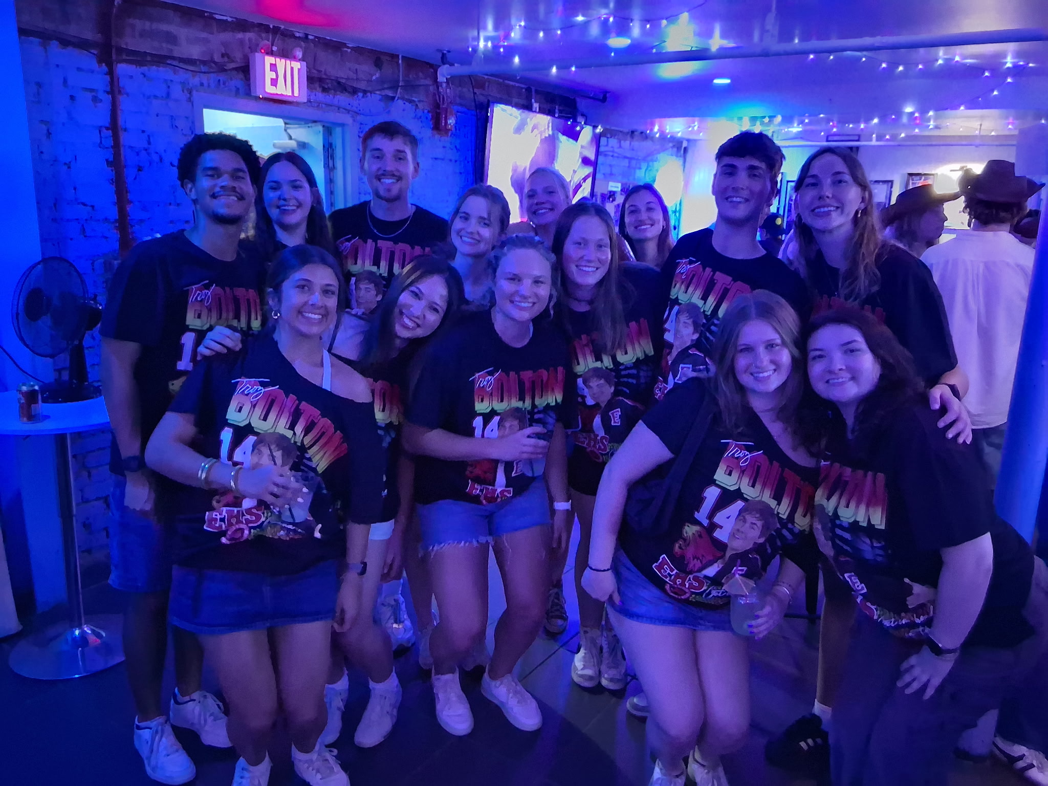 A group in matching theme-night shirts at Max's Tin Can
